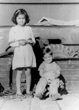 Celia with her brother, Winston, in Mayamyo, Burma, next to an Army lorry, 1946