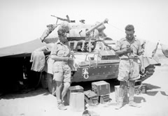April 1942. No. 1 Troop B Squadron (John Cloudsley-Thompson's second tank crew) before 'Knightsbridge'. Left: Trooper Joe Hocking (driver, K.I.A.). Right: Trooper Alf Carr (gunner, severely wounded) holding 'Noball' their pet fox cub. Corporal Norman Mew (wireless operator and loader, severely wounded) stayed inside the 'Bivvy' because it was too hot to come out just for a photograph!