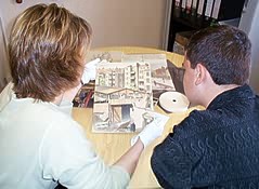 Claire Harder uses cotton gloves when showing Centre artwork to James Brown of Morley High School