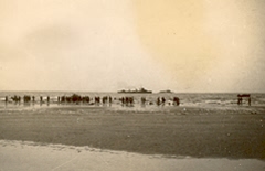 Another section of Dunkirk beach, Friday 31 May 1940. British troops watching and hoping. British destroyer waiting for chance to either come alongside mole or send boats to beach edge. L Barter. 